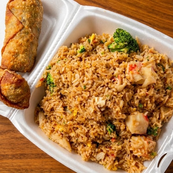 Two crispy egg rolls and a container of shrimp fried rice with broccoli and egg.